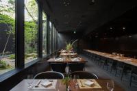 a dining room with tables and chairs and windows at Sowaka in Kyoto