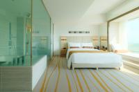 a bedroom with a white bed and a glass shower at The Prince Gallery Tokyo Kioicho, a Luxury Collection Hotel in Tokyo