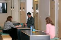 a man and two women sitting at a counter in a room at Citysleep in Luleå