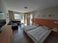 Posteľ alebo postele v izbe v ubytovaní Família Apartmanház