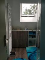 a bathroom with a window and a walk in closet at nid cauchois in Betteville