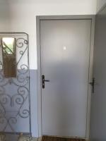 a white door with a mirror next to it at Appartement T2 in Lau-Balagnas