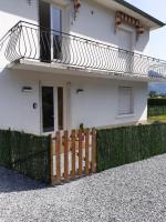 a white house with a wooden fence in front of it at appartement Isabelle in Lau-Balagnas