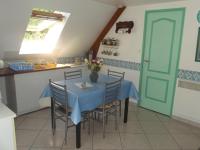 a dining room with a blue table and chairs at APPARTEMENT WISSANT in Wissant