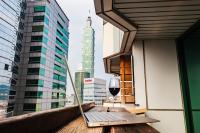 a laptop on a balcony with a glass of wine at Pacific Business Hotel in Taipei