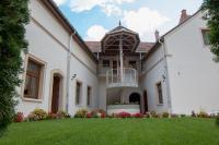 an exterior view of a white house with a yard at Mecset Apartman in Eger