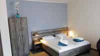 Łóżko lub łóżka w pokoju w obiekcie Hotel Giżycko