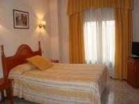A bed or beds in a room at Hostal Universal