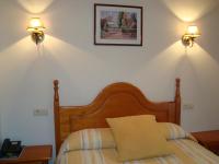 A bed or beds in a room at Hostal Universal