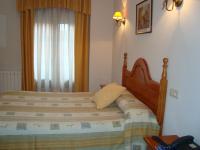 A bed or beds in a room at Hostal Universal