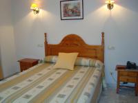 A bed or beds in a room at Hostal Universal