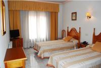 A bed or beds in a room at Hostal Universal