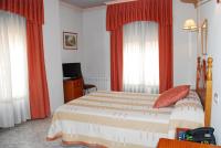 A bed or beds in a room at Hostal Universal