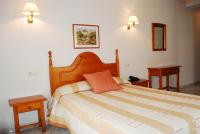 A bed or beds in a room at Hostal Universal