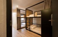 a room with two bunk beds and a doorway at Light Hostel in Chiayi City