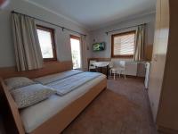 Posteľ alebo postele v izbe v ubytovaní Família Apartmanház