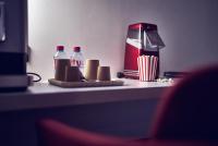 a table with bottles of soda and a popcorn at Maison Nô - Hôtel et Rooftop in Lyon