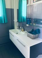 a bathroom with a white sink and a mirror at le gîte de Martine en Baie de Somme in Lanchères