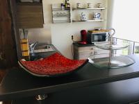 a kitchen with a red bowl on a counter at le gîte de Martine en Baie de Somme in Lanchères