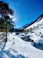 a snow covered mountain with a river and trees at T2 RESIDENCE 3 ETOILES Piscine chauffée Sauna Hammam in Cauterets