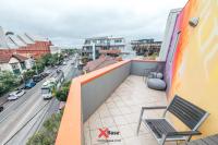 a balcony with a chair and a city street at Nomads St Kilda in Melbourne