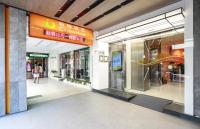 a shopping mall entrance with a woman walking through it at Cityinn Hotel Taipei Station Branch I in Taipei