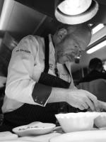 a man standing in a kitchen preparing food at Hostellerie de la Renaissance - Teritoria in Argentan