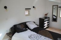 a bedroom with a bed with pillows and a dresser at Maison au pied de la cathédrale in Elne