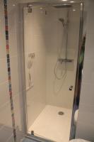 a shower with a glass door in a bathroom at Maison au pied de la cathédrale in Elne