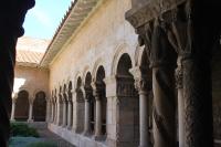 a building with columns and arches on the side at Maison au pied de la cathédrale in Elne