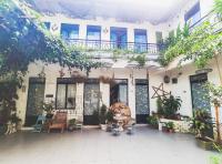 a courtyard of a building with a table and chairs at Da Lat Lemongrass - Đà Lạt Sả in Da Lat