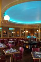 a restaurant with tables and chairs and a blue ceiling at Hôtel Vauban in Brest