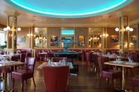 a restaurant with tables and chairs and a blue ceiling at Hôtel Vauban in Brest