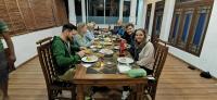 a group of people sitting at a table eating food at Nilowin Glenanore Guesthouse in Haputale
