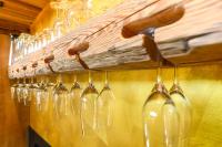 a row of wine glasses hanging on a wall at Gams Lodge in Goldegg