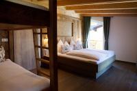 A bed or beds in a room at Alp-IN Lodges Kaprun