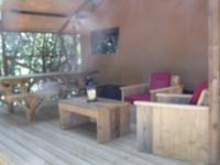 a living room with couches and a coffee table at Camping Mille Étoiles in Labastide-de-Virac