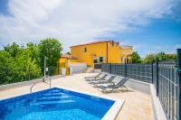 a swimming pool with chairs and a house at Villa &quot;Mile&quot; in Katuni