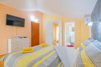 a bedroom with a bed with yellow towels on it at Villa &quot;Mile&quot; in Katuni