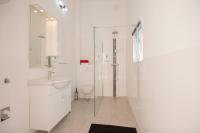 a white bathroom with a sink and a shower at Villa &quot;Mile&quot; in Katuni
