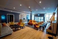 a living room with couches and tables and chairs at Caravelle Hotel im Park in Bad Kreuznach