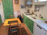 - une cuisine avec des placards verts, une table et un évier dans l&#39;établissement Mas de guffiage, à Bollène