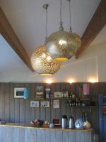 a kitchen with two chandeliers hanging from the ceiling at Camping Mille Étoiles in Labastide-de-Virac