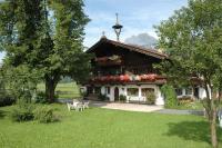 a house with a table and chairs in a yard at Appartement Oberlacken in Sankt Johann in Tirol