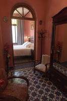 A bed or beds in a room at Hotel Casa Ceremines