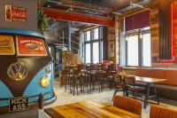 a restaurant with a table and chairs and a van at Kick Ass Greyfriars (18+) in Edinburgh