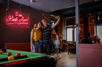 a man and a woman standing next to a pool table at Kick Ass Greyfriars (18+) in Edinburgh