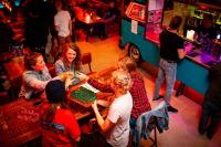 a group of people sitting around a table playing chess at Kick Ass Greyfriars (18+) in Edinburgh