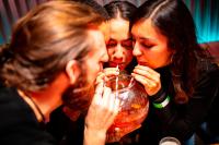 a group of three women drinking from a glass at Kick Ass Greyfriars (18+) in Edinburgh