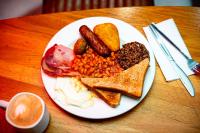 a plate of breakfast food with eggs bacon beans and toast at Kick Ass Greyfriars (18+) in Edinburgh